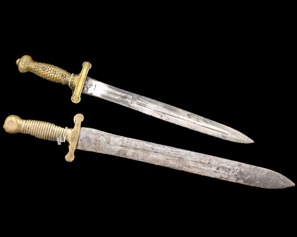 The M1832 sword with it's Conderate copy displayed from a diagonal angle, top left to bottom right.