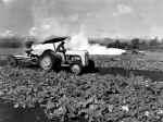 Tractor tilling a field.