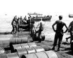 Soldiers transporting supplies from the dock to shore.