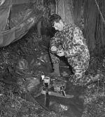 Soldier lighting a cooking fire.