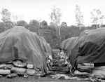 Supplies stored outside covered with tarps.