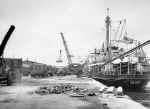 A docked ship being unloaded.