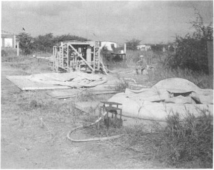 Collasible tank in the foreground and a skid-mounted ROWPU in the background.