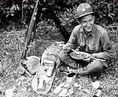 Soldier enjoying his rations with coffee.