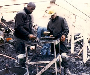 Workers analyzing debris from crash.